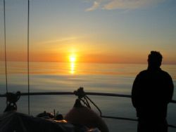 sunset at sea - notice the flatness of the sea...it's rig... by David Abecasis 